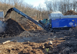 industrial shredder machine shredding green waste